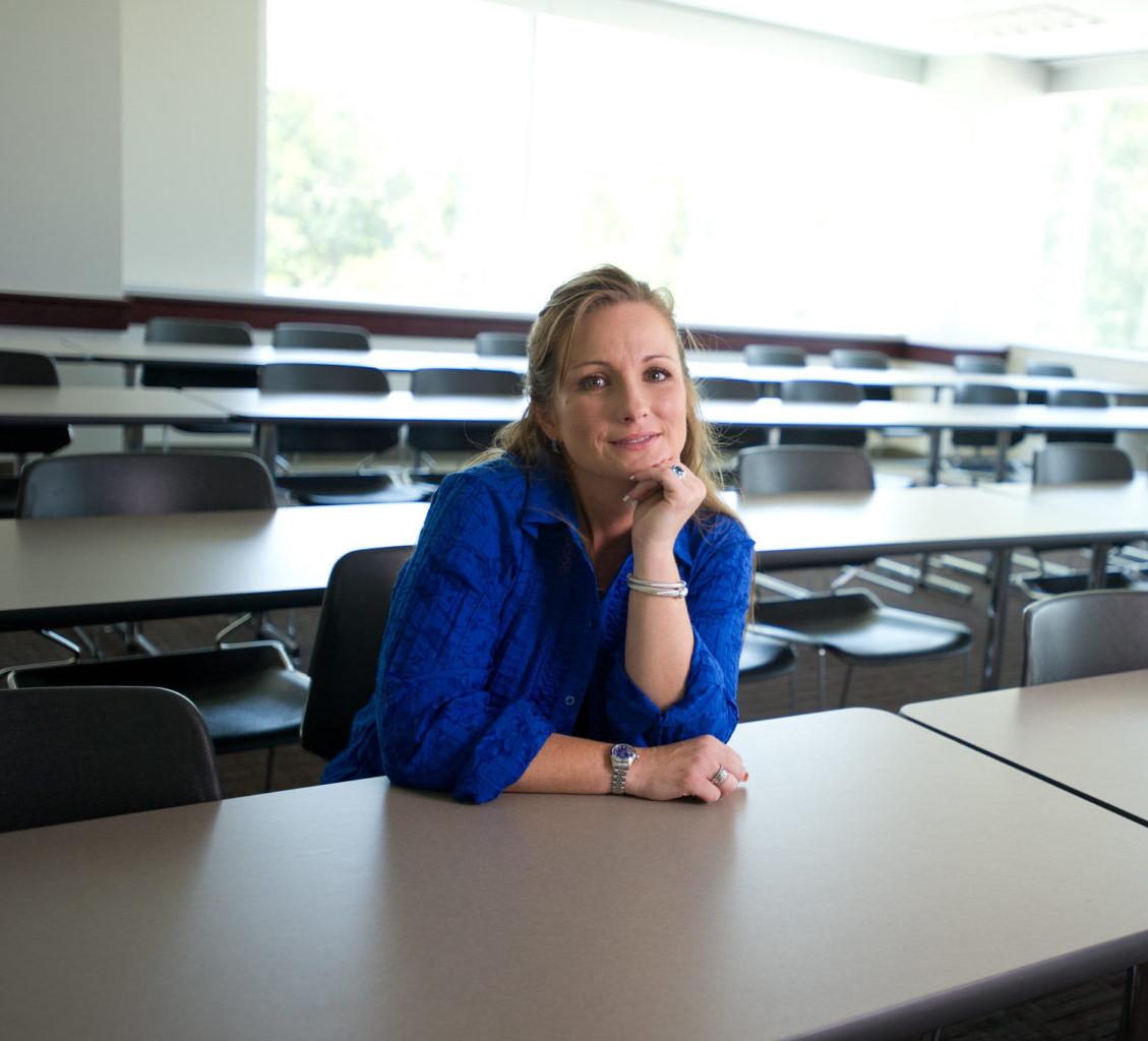 Higher education student sitting in a classroom.