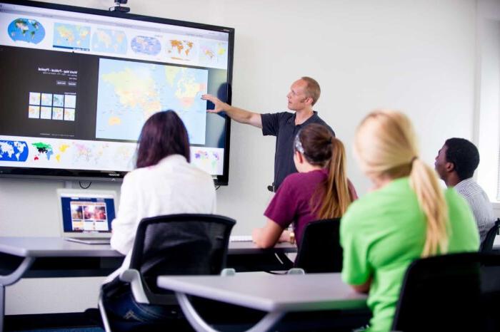 a professor showing something on a monitor during class