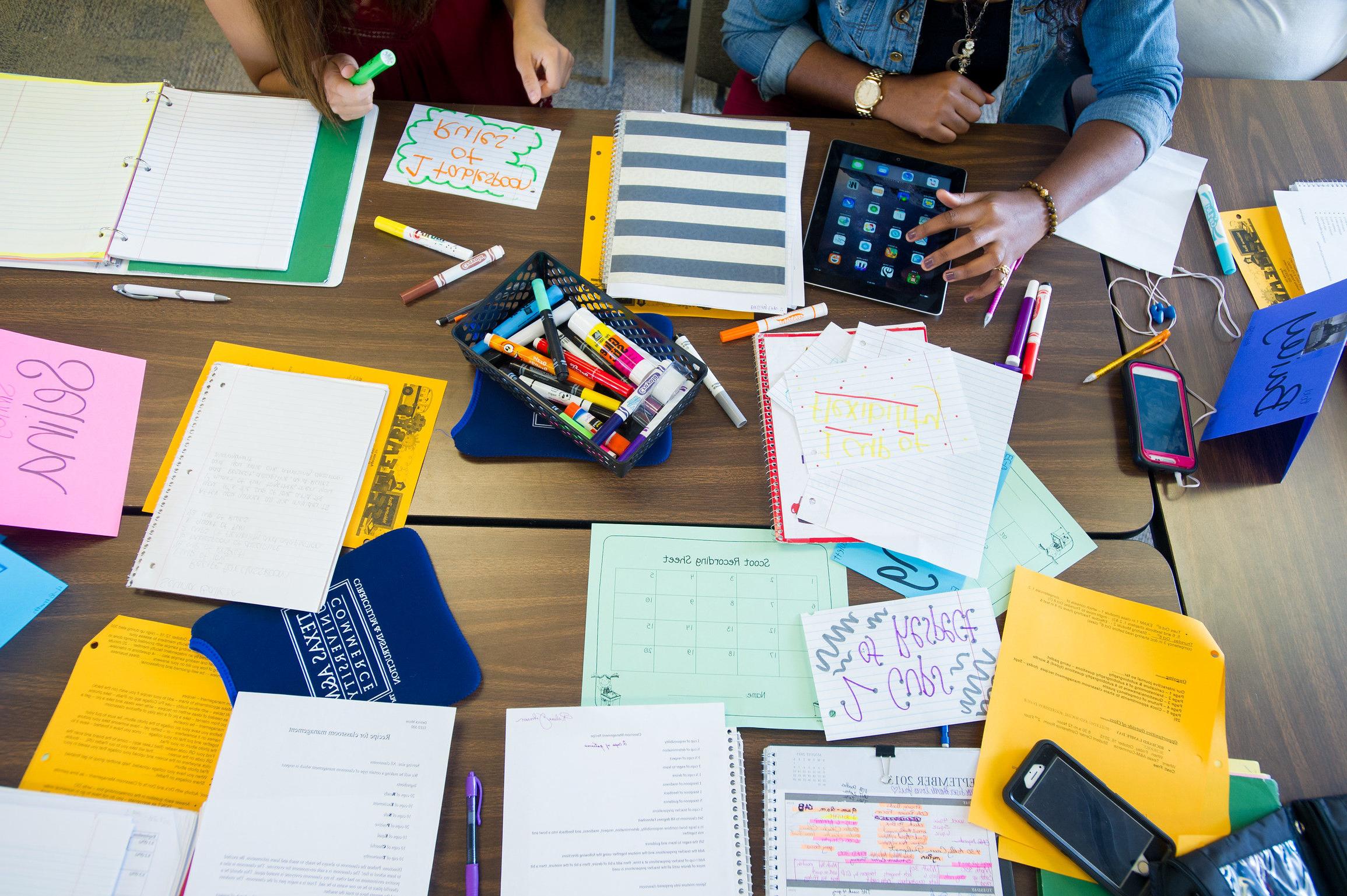 Desk with school supplies used by students.