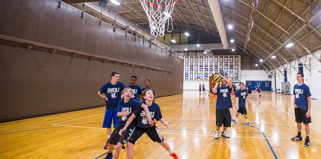 Youth team in the field house playing basketball.